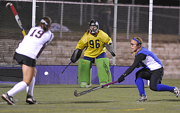 Nokomis' Leah Edmonson (19) hits the ball slightly wide of the post as Belfast goalkeeper Julia Ward and Brittany Mellor (right) defend during the first half of their Eastern Maine Class B field hockey final in Hampden Tuesday evening. Nokomis' Leah Edmonson (19) hits the ball slightly wide of the post as Belfast goalkeeper Julia Ward and Brittany Mellor (right) defend during the first half of their Eastern Maine Class B field hockey final in Hampden Tuesday evening.