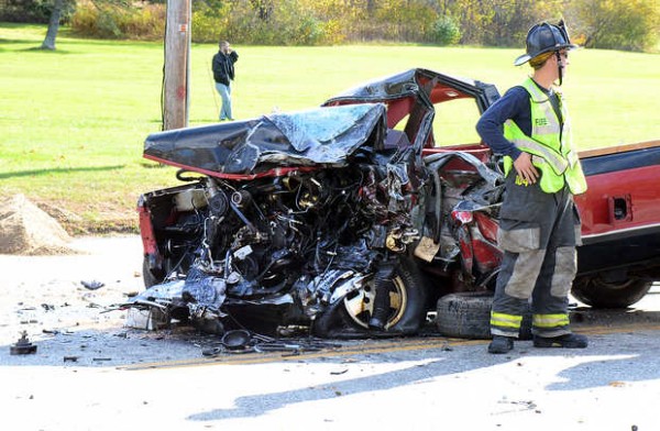 An Auburn firefighter stands next to the pickup that was involved in a head-on accident in front of St. Philips Church in Auburn. An Auburn firefighter stands next to the pickup that was involved in a head-on accident in front of St. Philips Church in Auburn.