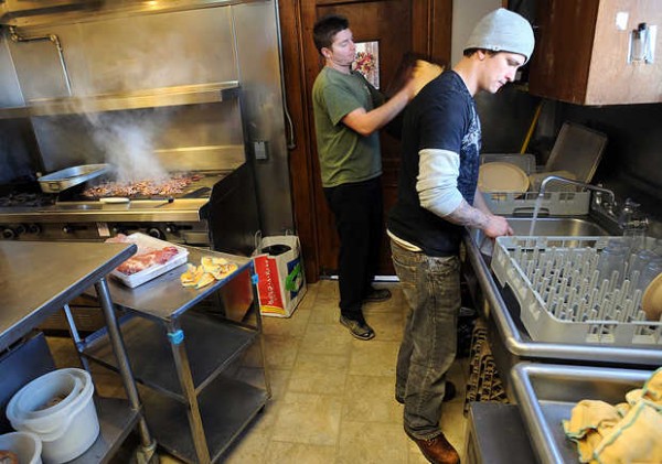 Nathan Brewer, right, and Dan Bell work in the kitchen while helping the cook prepare lunch for 32 residents at St. Francis Recovery Center in Auburn. Residents share chores throughout the home and on this particular day, Brewer and Bell chose to be kitchen aides. Nathan Brewer, right, and Dan Bell work in the kitchen while helping the cook prepare lunch for 32 residents at St. Francis Recovery Center in Auburn. Residents share chores throughout the home and on this particular day, Brewer and Bell chose to be kitchen aides.