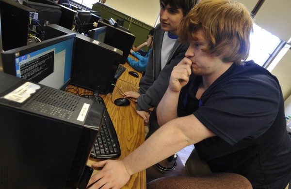 John Bapst seniors Ryan Bouchard and Carl Astbury, right, set up a computer for a classmate before it was used to go over a cyber defense vulnerabilty checklist during Thursday afternoon's practice session at the high school for an upcoming national cyber security competition. John Bapst seniors Ryan Bouchard and Carl Astbury, right, set up a computer for a classmate before it was used to go over a cyber defense vulnerabilty checklist during Thursday afternoon's practice session at the high school for an upcoming national cyber security competition.