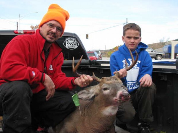 "Cussy" Arsenault and his son, Damien, 10, both of Rumford, proudly display dad's first deer. The 8-point buck weighed 193½ pounds on the scale at the Rumford Fire Department tagging station Saturday, the opening day of Maine's regular firearms deer season. "Cussy" Arsenault and his son, Damien, 10, both of Rumford, proudly display dad's first deer. The 8-point buck weighed 193½ pounds on the scale at the Rumford Fire Department tagging station Saturday, the opening day of Maine's regular firearms deer season.