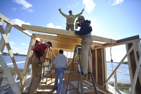 With arms outstretched, a spirited Capt. Bruce Dunham stands atop the ship wheelhouse as he and fellow volunteers Don Locke of Highland Village, Texas, Dunham's partner, Sheila Young, and Matt Novak (standing on ladder) of Wellington, Ohio, get to work Thursday, Oct. 6, 2011 on the 65-foot, two-masted wooden schooner that they hope to finish building in Addison. The ship construction was started in 1986 by the late Dino Fonda of Addison. With arms outstretched, a spirited Capt. Bruce Dunham stands atop the ship wheelhouse as he and fellow volunteers Don Locke of Highland Village, Texas, Dunham's partner, Sheila Young, and Matt Novak (standing on ladder) of Wellington, Ohio, get to work Thursday, Oct. 6, 2011 on the 65-foot, two-masted wooden schooner that they hope to finish building in Addison. The ship construction was started in 1986 by the late Dino Fonda of Addison.