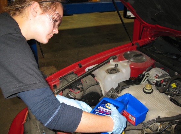 Sophia Schmauderer, 17, of Machiasport, a student at Washington Academy in East Machias, removes the oil cap on a car in the Automotive Techonology lab at Washington County Community College in Calais. Instructor Ron O'Brien showed a group of young women on how to change the oil and check other key components on a car during the Totally Trades Conference on Friday. Sophia Schmauderer, 17, of Machiasport, a student at Washington Academy in East Machias, removes the oil cap on a car in the Automotive Techonology lab at Washington County Community College in Calais. Instructor Ron O'Brien showed a group of young women on how to change the oil and check other key components on a car during the Totally Trades Conference on Friday.