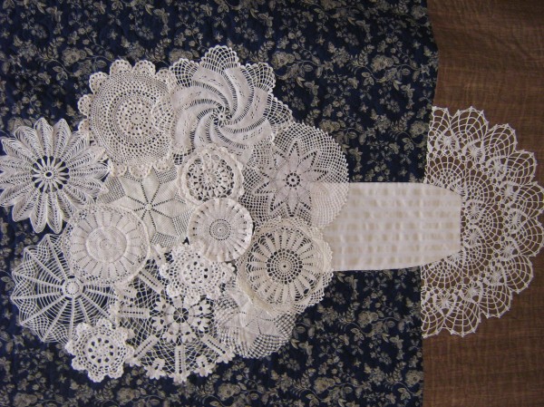 Quilter Carolee Withee created this wallhanging using vintage hand crocheted doilies. Withee hand-colored the lower section, representing a table. Quilter Carolee Withee created this wallhanging using vintage hand crocheted doilies. Withee hand-colored the lower section, representing a table.
