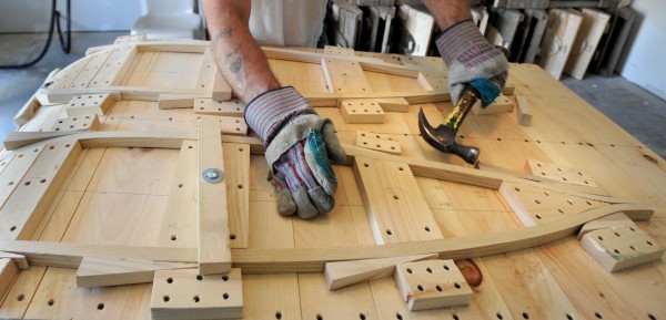 Gary Wozneak hammers wedges along the frame of a Maine Guide snowshoe after he bent the steamed wood. He is one of about seven inmates at the Charleston Correctional Facility who make snowshoe frames from raw material to the finished product. The webbing is later tied onto the snowshoes by veteran in Augusta. Gary Wozneak hammers wedges along the frame of a Maine Guide snowshoe after he bent the steamed wood. He is one of about seven inmates at the Charleston Correctional Facility who make snowshoe frames from raw material to the finished product. The webbing is later tied onto the snowshoes by veteran in Augusta.
