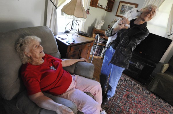 Thelma Lawrence (seated), 84, watches her 2-year-old Maltese, Lily, smooch Gloria DeNicola of Newport during one of DeNicola's regular visits to check up on Lawrence at her home in Madison on Friday, Sept. 30, 2011. DeNicola is a volunteer with the Senior Companion program which is administered by the Cooperative Extension Service. Thelma Lawrence (seated), 84, watches her 2-year-old Maltese, Lily, smooch Gloria DeNicola of Newport during one of DeNicola's regular visits to check up on Lawrence at her home in Madison on Friday, Sept. 30, 2011. DeNicola is a volunteer with the Senior Companion program which is administered by the Cooperative Extension Service.