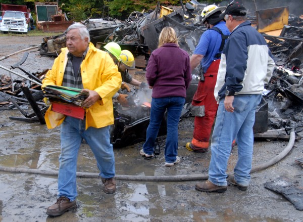 Day's Welding & Machine owner Richard "Dickie" Day salvages
files from the remains of his shop at 16 Main Road in Medway after it
was totally destroyed in a fire on Monday, Oct. 3, 2011. Day's Welding & Machine owner Richard "Dickie" Day salvages
files from the remains of his shop at 16 Main Road in Medway after it
was totally destroyed in a fire on Monday, Oct. 3, 2011.