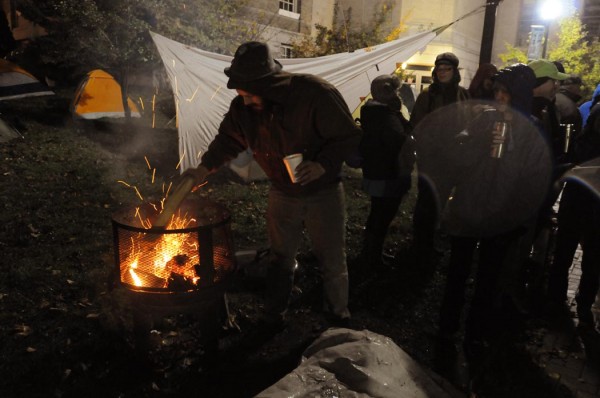 A member of Occupy Bangor stokes a wood fire on the lawn of the Bangor Public Library on Saturday, October 29, 2011. The occupiers were forced out of Peirce park after 10 p.m. due to a city ordinance. A member of Occupy Bangor stokes a wood fire on the lawn of the Bangor Public Library on Saturday, October 29, 2011. The occupiers were forced out of Peirce park after 10 p.m. due to a city ordinance.