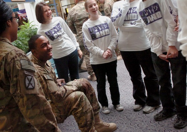 2nd Lt. Andre Mathews of Georgia (second from left) shares a laugh with members of the John Bapst band at Bangor International Airport on Wednesday, October 19, 2011. The band, with special guest musician Master Sgt. Kevin Tillman, joined the Maine Troop Greeters in welcoming the soldiers to Bangor before they head overseas. 2nd Lt. Andre Mathews of Georgia (second from left) shares a laugh with members of the John Bapst band at Bangor International Airport on Wednesday, October 19, 2011. The band, with special guest musician Master Sgt. Kevin Tillman, joined the Maine Troop Greeters in welcoming the soldiers to Bangor before they head overseas.
