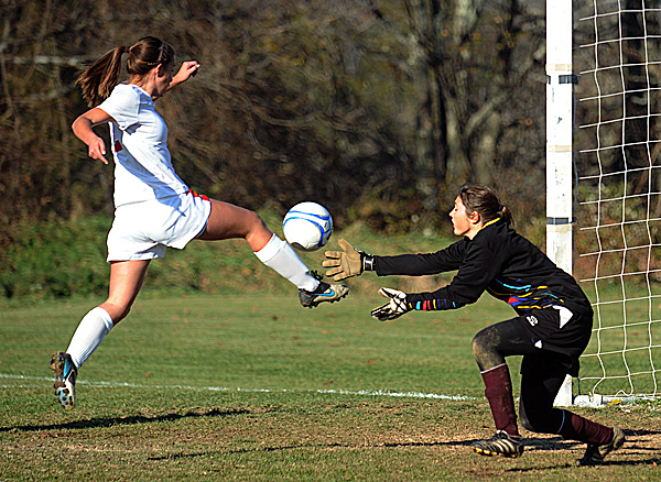 Central High School's Brianna Speed (left) knocks the ball into the net past Orono High School goalkeeper Taylor Gray to score her team's first goal during the Eastern Maine Class C girls soccer championship in Corinth Wednesday. Central won 4-3 after the second round of penalty kicks. Central High School's Brianna Speed (left) knocks the ball into the net past Orono High School goalkeeper Taylor Gray to score her team's first goal during the Eastern Maine Class C girls soccer championship in Corinth Wednesday. Central won 4-3 after the second round of penalty kicks.