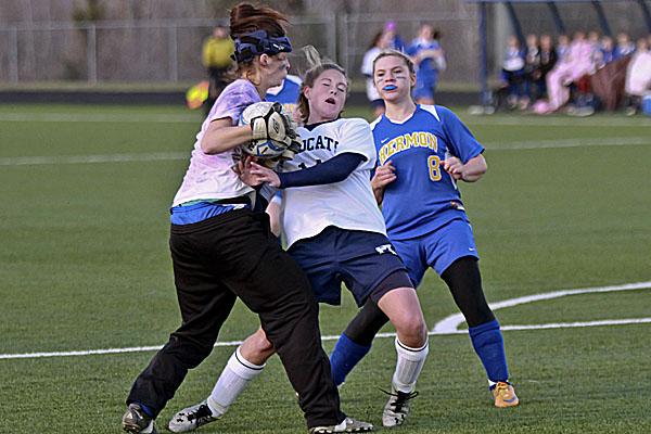 Hermon High School goalkeeper Mikayla Treadwell latches onto the ball just ahead of a hard-charging Chandler Guerrette of Presque Isle in Wednesday's Eastern Maine Class B girls soccer semifinal at the University of Maine-Presque Isle's Johnson Athletic Complex. Hermon's Amanda Allen looks on. Guerrette scored both goals in the the Wildcats' 2-0 victory. Hermon High School goalkeeper Mikayla Treadwell latches onto the ball just ahead of a hard-charging Chandler Guerrette of Presque Isle in Wednesday's Eastern Maine Class B girls soccer semifinal at the University of Maine-Presque Isle's Johnson Athletic Complex. Hermon's Amanda Allen looks on. Guerrette scored both goals in the the Wildcats' 2-0 victory.