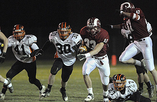 Protected by teammate Ellis Throckmorton (47), Bangor's Cody Chapman (33) leaves Brunswick's Hunter Ouellette (41), Sam Bessey (30), Tom Purington (27) and others in his wake as he runs it into the end zone to score early in the first quarter of Friday night's Eastern Maine Class A football semifinal at Cameron Stadium in Bangor. Protected by teammate Ellis Throckmorton (47), Bangor's Cody Chapman (33) leaves Brunswick's Hunter Ouellette (41), Sam Bessey (30), Tom Purington (27) and others in his wake as he runs it into the end zone to score early in the first quarter of Friday night's Eastern Maine Class A football semifinal at Cameron Stadium in Bangor.