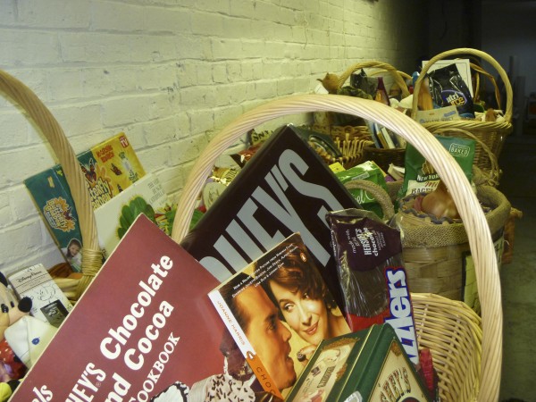 A long table of gift baskets in the process of being completed line a wall in the cellar of the Hammond Street Senior Center. The gift baskets will be up for bid in a silent auction set for Dec. 5-9 at the center. A long table of gift baskets in the process of being completed line a wall in the cellar of the Hammond Street Senior Center. The gift baskets will be up for bid in a silent auction set for Dec. 5-9 at the center.