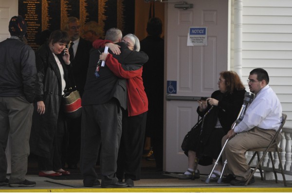 Mourners embrace as they leave East Orrington Congregational Church after Friday afternoon's memorial service for Rev. Robert Carlson. Mourners embrace as they leave East Orrington Congregational Church after Friday afternoon's memorial service for Rev. Robert Carlson.