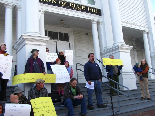 Dan Brown, owner of Gravelwood Farm in Blue Hill, speaks to a crowd of more than 150 people gathered Friday, Nov. 18, 2011, in front of the Blue Hill Town Hall. The Maine Department of Agriculture has filed a suit against Brown, alleging that he is illegally selling unpasteurized milk without a license. Brown, meanwhile, insists he is doing nothing wrong and that a local food ordinance adopted by Blue Hill residents protects the rights of farmers to sell directly to consumers without a license. Dan Brown, owner of Gravelwood Farm in Blue Hill, speaks to a crowd of more than 150 people gathered Friday, Nov. 18, 2011, in front of the Blue Hill Town Hall. The Maine Department of Agriculture has filed a suit against Brown, alleging that he is illegally selling unpasteurized milk without a license. Brown, meanwhile, insists he is doing nothing wrong and that a local food ordinance adopted by Blue Hill residents protects the rights of farmers to sell directly to consumers without a license.