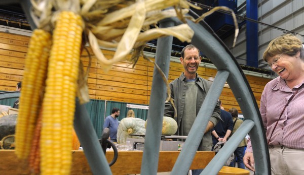 Karen Cousins of Orland (right) shares a laugh with Jay Robbins of Sweet Land Farm in Starks during the first Harvest Festival at the Bangor Auditorium Sunday. Karen Cousins of Orland (right) shares a laugh with Jay Robbins of Sweet Land Farm in Starks during the first Harvest Festival at the Bangor Auditorium Sunday.