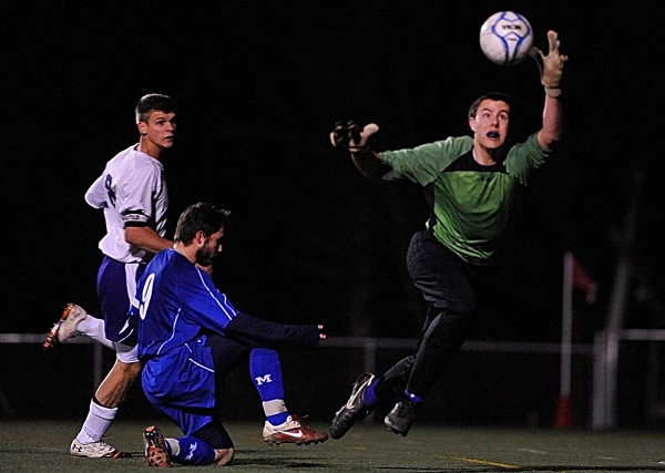 Hampden Academy goal keeper Logan Poirier deflects a score attempt by Messalonskee's Chris Hall (#9) during the second half of their Class A Boys Eastern Maine Soccer Championship in Hampden on Wednesday night, Nov. 2, 2011. On the left is Hampden teammate Kent Reichel. Hampden Academy goal keeper Logan Poirier deflects a score attempt by Messalonskee's Chris Hall (#9) during the second half of their Class A Boys Eastern Maine Soccer Championship in Hampden on Wednesday night, Nov. 2, 2011. On the left is Hampden teammate Kent Reichel.
