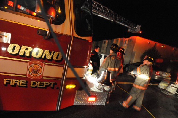 Orono, Old Town and Veazie firefighters gather near a ladder truck in the aftermath of a fire at Stillwater Village Apartments off College Avenue in Orono Saturday evening, Nov 19, 2011. Orono, Old Town and Veazie firefighters gather near a ladder truck in the aftermath of a fire at Stillwater Village Apartments off College Avenue in Orono Saturday evening, Nov 19, 2011.