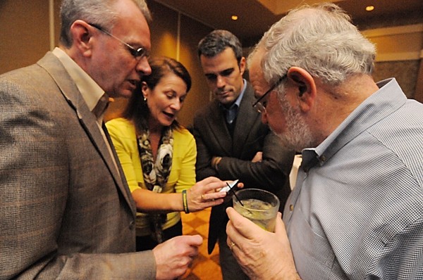Hollywood Slots General Manager John Osborne (from left), Penn National/ Hollywood Slots Lobbyist Cheryl Timberlake, Penn National Senior Vice President for Public Affairs Eric Schippers and Arena Yes! co-chair Miles Theeman look over early polling results for the southern Maine gaming votes on a smartphone as they wait for the Penobscot table games voting results to come in during their election night gathering at Hollywood Slots Hotel in Bangor on Tuesday night. Hollywood Slots General Manager John Osborne (from left), Penn National/ Hollywood Slots Lobbyist Cheryl Timberlake, Penn National Senior Vice President for Public Affairs Eric Schippers and Arena Yes! co-chair Miles Theeman look over early polling results for the southern Maine gaming votes on a smartphone as they wait for the Penobscot table games voting results to come in during their election night gathering at Hollywood Slots Hotel in Bangor on Tuesday night.