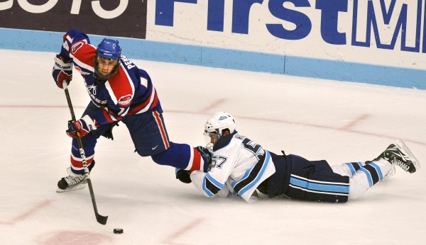 The University of Maine's Matt Mangene (right) hangs onto UMass Lowell's Joseph Pendenza during the third period of the game at the Alfond Arena in Orono on Saturday. Mangene got a two-minute penelty for holding and Lowell scored on the power play. The University of Maine's Matt Mangene (right) hangs onto UMass Lowell's Joseph Pendenza during the third period of the game at the Alfond Arena in Orono on Saturday. Mangene got a two-minute penelty for holding and Lowell scored on the power play.