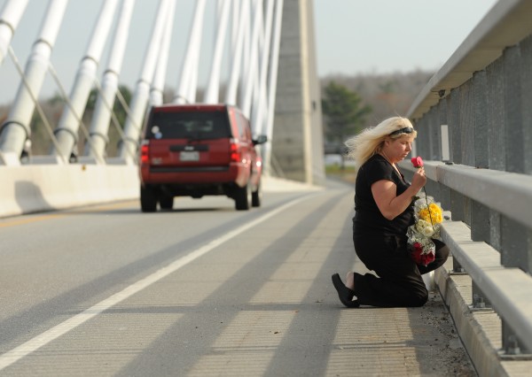 "For you there wil be no crying. For you the sun will be shining," said a woman asking not to be identified as she tossed flowers off the Penobscot Narrows Bridge on Monday, Nov. 14, 2011. She was honoring the memory of Rev. Bob Carlson, who jumped from the bridge on Sunday. She explained that Rev. Carlson had talked her out of jumping off the same bridge in June of 2010. "I was supposed to be in the water," she said. "For you there wil be no crying. For you the sun will be shining," said a woman asking not to be identified as she tossed flowers off the Penobscot Narrows Bridge on Monday, Nov. 14, 2011. She was honoring the memory of Rev. Bob Carlson, who jumped from the bridge on Sunday. She explained that Rev. Carlson had talked her out of jumping off the same bridge in June of 2010. "I was supposed to be in the water," she said.