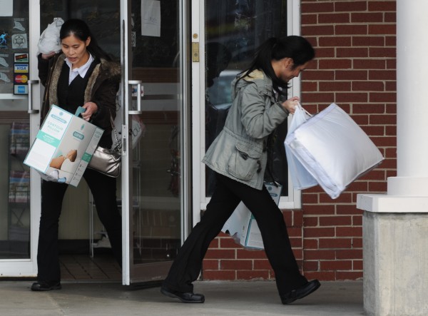 Women run from the Twin Super Buffet in Brewer on Wednesday, November 16, 2011. Federal agents were seen removing boxes earlier. Women run from the Twin Super Buffet in Brewer on Wednesday, November 16, 2011. Federal agents were seen removing boxes earlier.