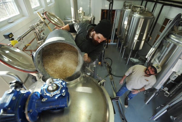 Andy Geaghan pours the last of almost 400 pounds of grain into the mash tun at Geaghan Brothers Brewing Co. in Geaghan's Pub in Bangor on Monday, Nov. 21, 2011, as brew master Jason Courtney watches. Andy Geaghan pours the last of almost 400 pounds of grain into the mash tun at Geaghan Brothers Brewing Co. in Geaghan's Pub in Bangor on Monday, Nov. 21, 2011, as brew master Jason Courtney watches.