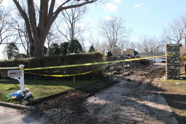 Yellow tape stretches across the driveway, Monday, Dec. 26, 2011, at the house where a fire left five people dead Christmas Day, in Stamford, Conn. Yellow tape stretches across the driveway, Monday, Dec. 26, 2011, at the house where a fire left five people dead Christmas Day, in Stamford, Conn.