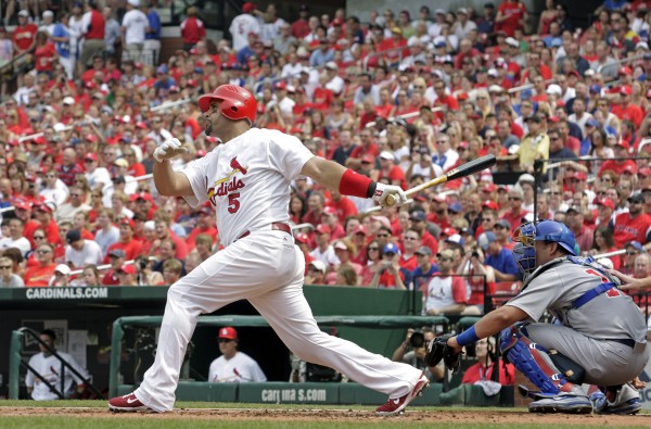 St. Louis Cardinals first baseman Albert Pujols (5) follows through on a solo home run as Chicago Cubs catcher Geovany Soto watches in the first inning of a baseball game, in St. Louis on July 30, 2011. St. Louis Cardinals first baseman Albert Pujols (5) follows through on a solo home run as Chicago Cubs catcher Geovany Soto watches in the first inning of a baseball game, in St. Louis on July 30, 2011.