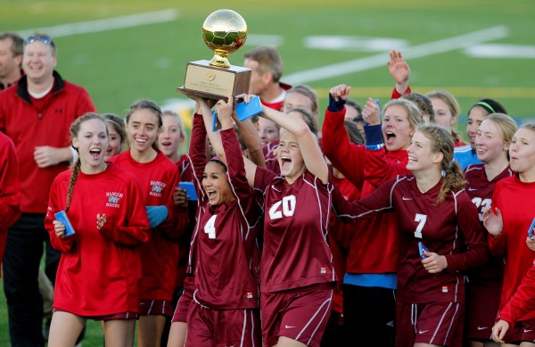 Bangor's Jade Baumrind (4) and Elizabeth Hintz (20) lead their teammates in a celebration with the trophy after defeating Scarborough in the Class A soccer state championship in Falmouth on Saturday, Nov. 5, 2011. Bangor's Jade Baumrind (4) and Elizabeth Hintz (20) lead their teammates in a celebration with the trophy after defeating Scarborough in the Class A soccer state championship in Falmouth on Saturday, Nov. 5, 2011.