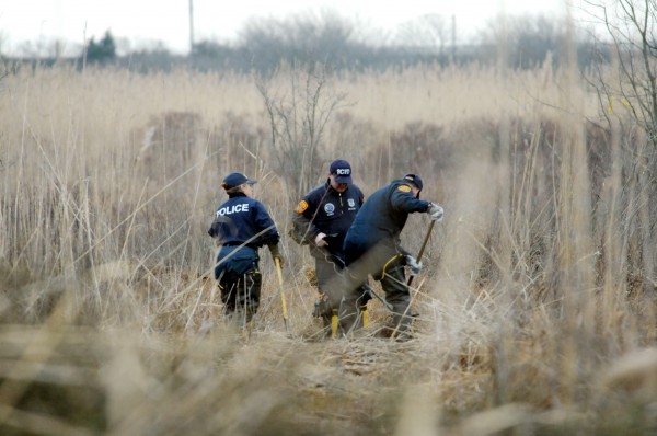 Crime Scene investigators use metal detectors to search a marsh for the remains of Shannan Gilbert on Monday, Dec. 12, 2011 in Oak Beach, New York. Crime Scene investigators use metal detectors to search a marsh for the remains of Shannan Gilbert on Monday, Dec. 12, 2011 in Oak Beach, New York.