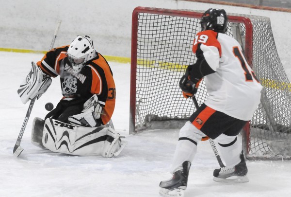 Winslow High School goaltender Cameron Tibbetts deflects a score attempt from Brewer High School's Kyle Alexander in the third period of their game at Penobscot Ice Arena in Brewer on Tuesday afternoon, Dec. 20, 2011. Brewer defeated Winslow 7-1. Winslow High School goaltender Cameron Tibbetts deflects a score attempt from Brewer High School's Kyle Alexander in the third period of their game at Penobscot Ice Arena in Brewer on Tuesday afternoon, Dec. 20, 2011. Brewer defeated Winslow 7-1.