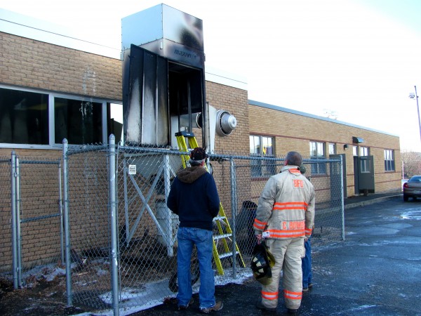 Bucksport Fire Department Chief Craig Bowden (center) examines a dust collection unit that caught fire on Thursday, Dec. 22, 2011, outside of the wood shop at Bucksport High School. Bucksport Fire Department Chief Craig Bowden (center) examines a dust collection unit that caught fire on Thursday, Dec. 22, 2011, outside of the wood shop at Bucksport High School.