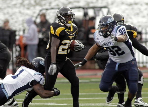 Appalachian State's Cedric Baker Boney (29) runs between Maine's Raibonne Charles (92) and Jerron McMillian (1) during the first half of an NCAA college football game, Saturday, Dec. 3, 2011, in Boone, N.C. Appalachian State's Cedric Baker Boney (29) runs between Maine's Raibonne Charles (92) and Jerron McMillian (1) during the first half of an NCAA college football game, Saturday, Dec. 3, 2011, in Boone, N.C.