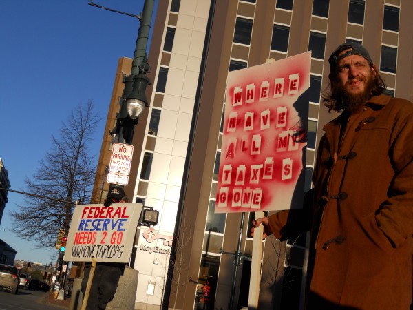 Matthew Coffey (right) is among those holding signs in acknowledgement of OccupyMaine's two months in Portland on Thursday in Monument Square. Matthew Coffey (right) is among those holding signs in acknowledgement of OccupyMaine's two months in Portland on Thursday in Monument Square.