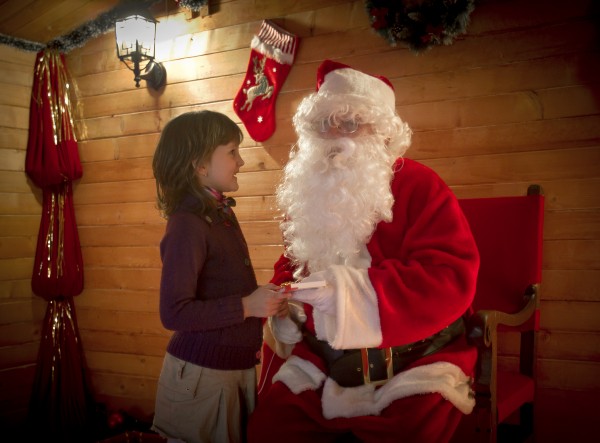 A child reacts after receiving a chocolate bar from a person dressed as Santa Claus at a shopping mall in Bucharest, Romania, Thursday, Dec. 15, 2011. A child reacts after receiving a chocolate bar from a person dressed as Santa Claus at a shopping mall in Bucharest, Romania, Thursday, Dec. 15, 2011.