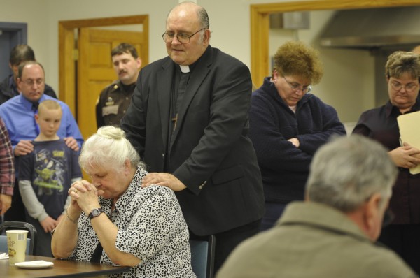 The Rev. Stephen Dean, pastor of the United Methodist Churches in Guilford and Ripley, his wife, Glenna Dean (bottom left), and other friends and family of Udo Schneider bow their heads in prayer as they remember the man who touched their lives during a celebration of Schneider's life at Mount Kineo Masonic Lodge in Guilford Tuesday afternoon, Dec. 6, 2011. The Rev. Stephen Dean, pastor of the United Methodist Churches in Guilford and Ripley, his wife, Glenna Dean (bottom left), and other friends and family of Udo Schneider bow their heads in prayer as they remember the man who touched their lives during a celebration of Schneider's life at Mount Kineo Masonic Lodge in Guilford Tuesday afternoon, Dec. 6, 2011.