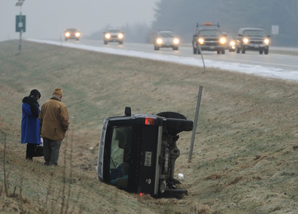 Sarah Courtney (left) of Orrington uses her cellphone to call for help as she stands with a man asking not to be identified along the side of the northbound lane of Intersate 95 in Bangor on Wednesday, Dec. 21, 2011. Courtney claims she was bumped by a passing white Ford Focus which sent her spinning off the ice-covered roadway. Sarah Courtney (left) of Orrington uses her cellphone to call for help as she stands with a man asking not to be identified along the side of the northbound lane of Intersate 95 in Bangor on Wednesday, Dec. 21, 2011. Courtney claims she was bumped by a passing white Ford Focus which sent her spinning off the ice-covered roadway.