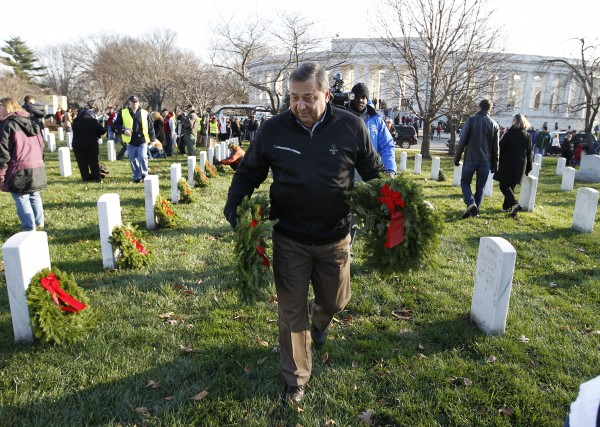 Gov. Paul LePage of Maine volunteers to lay holiday wreaths at the graves of fallen soldiers at Arlington National Cemetery in Washington on Saturday Dec. 10, 2011, during Wreaths Across America Day. Gov. Paul LePage of Maine volunteers to lay holiday wreaths at the graves of fallen soldiers at Arlington National Cemetery in Washington on Saturday Dec. 10, 2011, during Wreaths Across America Day.