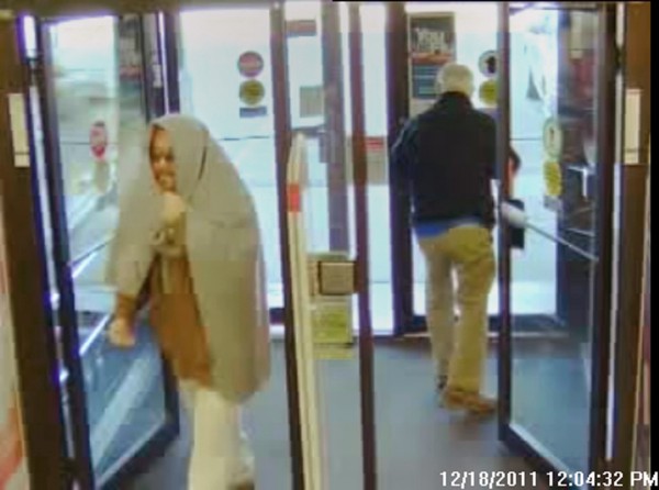 Security camera footage of the suspect entering the building. Security camera footage of the suspect entering the building.