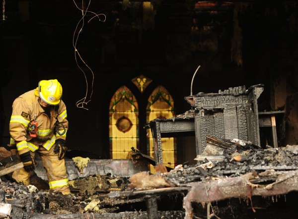 Thorndike firefighter Scott Cooper checks for what appeared to be smoulderig debris inside the Thorndile Congregational Church on Wednesday Dec. 28, 2011. The church was reported in flames by a passerby during the early morning hours of Wednesday. Thorndike firefighter Scott Cooper checks for what appeared to be smoulderig debris inside the Thorndile Congregational Church on Wednesday Dec. 28, 2011. The church was reported in flames by a passerby during the early morning hours of Wednesday.