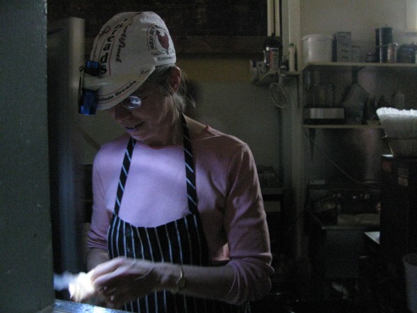 Pam McKeen prepared food Saturday by the light of a makeshift headlamp at Chase's Daily in Belfast. The restaurant was one of the few in the midcoast city to stay open during the nearly five-hour-long outage that day. Pam McKeen prepared food Saturday by the light of a makeshift headlamp at Chase's Daily in Belfast. The restaurant was one of the few in the midcoast city to stay open during the nearly five-hour-long outage that day.