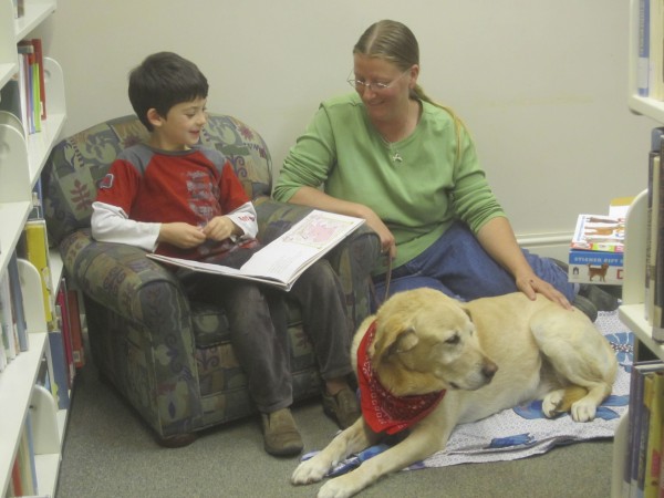 Rebecca Henderson and her "Listening Lab," Atticus, enjoy a reading session with Adam. Rebecca Henderson and her "Listening Lab," Atticus, enjoy a reading session with Adam.