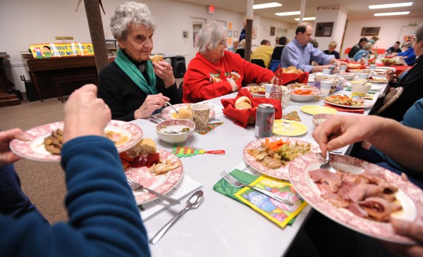 Mary Huskins (left) of Orono and Annie Dudley of Bangor share a Christmas meal at the Brewer Congregational Church on Sunday, Dec. 25, 2011. Mary Huskins (left) of Orono and Annie Dudley of Bangor share a Christmas meal at the Brewer Congregational Church on Sunday, Dec. 25, 2011.