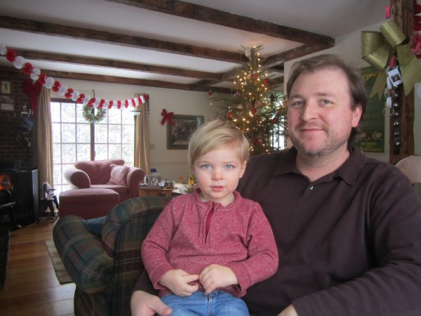 Richard Reinhart, stay-at-home dad, with his son, Henry. Their Christmas tree awaits a belated celebration with out-of-town family. Richard Reinhart, stay-at-home dad, with his son, Henry. Their Christmas tree awaits a belated celebration with out-of-town family.