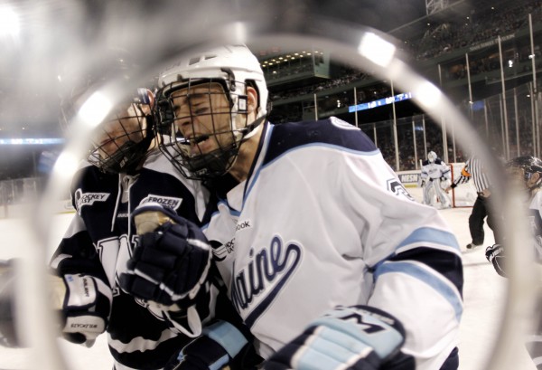 Maine's Mark Nemec (right) is checked by New Hampshire's Nick Sorkin during the second period of an NCAA college hockey game at Fenway Park in Boston, Saturday, Jan. 7, 2012. Maine's Mark Nemec (right) is checked by New Hampshire's Nick Sorkin during the second period of an NCAA college hockey game at Fenway Park in Boston, Saturday, Jan. 7, 2012.