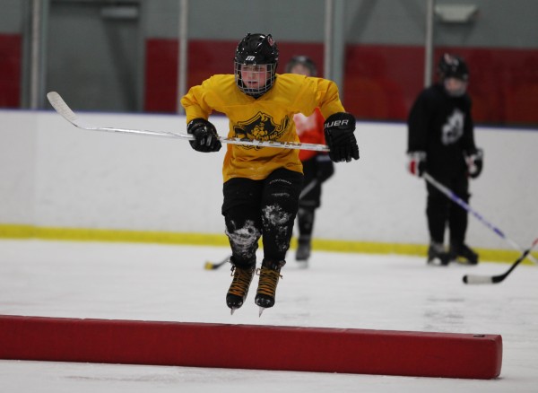 Portland Junior Pirates 2000AA player Jameson Bakke, jumps over an obstacle during practice Wednesday, Jan. 18, 2012 in Saco, Maine. Portland Junior Pirates 2000AA player Jameson Bakke, jumps over an obstacle during practice Wednesday, Jan. 18, 2012 in Saco, Maine.
