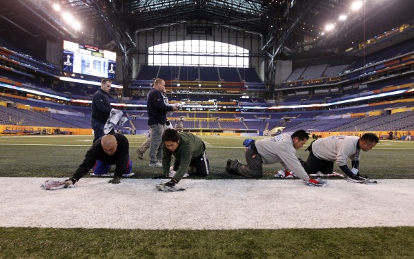 Members of the ground crew clean the field in Lucas Oil Stadium as preparations continue for Super Bowl XLVI in Indianapolis on Wednesday, Jan. 25, 2012. The New England Patriots are to face the New York Giants on Feb. 5. Members of the ground crew clean the field in Lucas Oil Stadium as preparations continue for Super Bowl XLVI in Indianapolis on Wednesday, Jan. 25, 2012. The New England Patriots are to face the New York Giants on Feb. 5.
