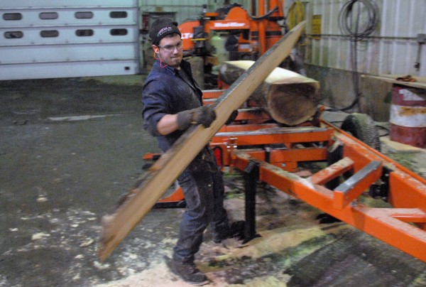 Kelby Pelletier, a loader-operator at West Branch Heritage Timber LLC, takes a fresh-cut plank off the sawmill at the company's Golden Road headquarters on Thursday, Jan. 5, 2011. Kelby Pelletier, a loader-operator at West Branch Heritage Timber LLC, takes a fresh-cut plank off the sawmill at the company's Golden Road headquarters on Thursday, Jan. 5, 2011.