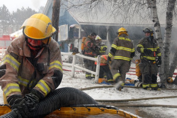 Firefighters from five northern Penobscot County towns trucked water to the scene despite blizzard-like conditions but were unable to save from destruction a 1 1/2-story house and attached garage at 91 Old County Road in Enfield on Thursday, Jan. 12, 2011. Firefighters from five northern Penobscot County towns trucked water to the scene despite blizzard-like conditions but were unable to save from destruction a 1 1/2-story house and attached garage at 91 Old County Road in Enfield on Thursday, Jan. 12, 2011.